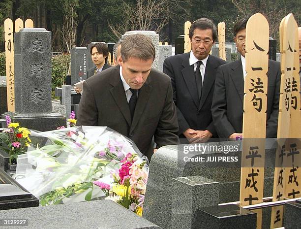 Japanese truckmaker Mitsubishi Fuso Truck and Bus Corp. President and CEO Wilfried Porth lays bouquet of flowers in front of the grave of Shiho...