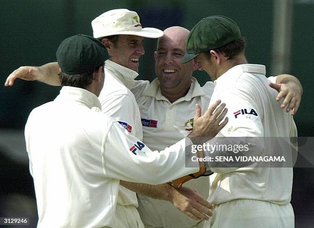 Australian cricketer Darren Lehmann celebrates with teammates Adam Gilchrist Matthew Hayden and Ricky Ponting after the dismissal of Sri lankan...