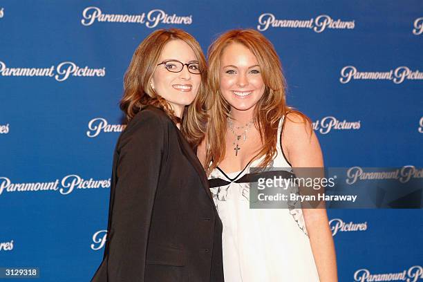 Actresses Tina Fey and Lindsay Lohan pose for pictures as they arrive for the ShoWest Paramount Pictures Gala on March 24, 2004 in Las Vegas, Nevada.