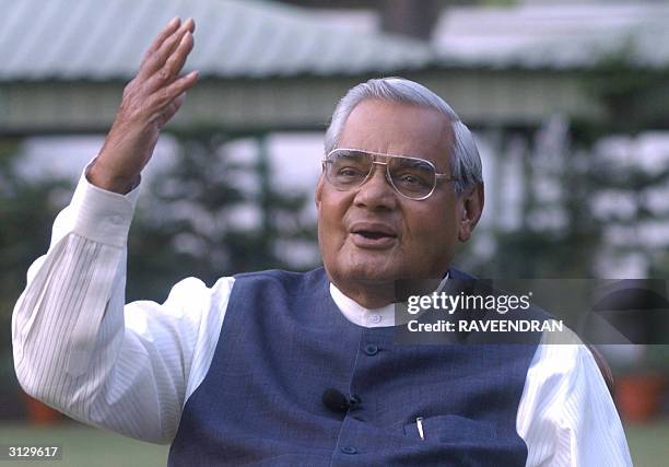 India's Prime Minister Atal Behari Vajpayee gestures as he poses for photographers at his residence in New Delhi, 25 March 2004. Vajpayee together...