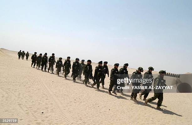 Japanese Self Defense Ground Forces soldiers attend a shooting practice session at the Udaira range in the desert, 120 kms north of Kuwait City, 25...