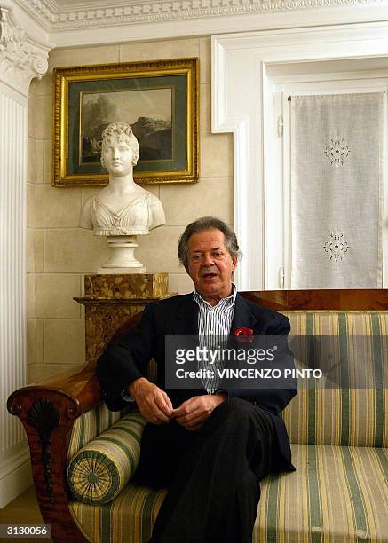 Renowned Italian art editor Franco Maria Ricci sits in front of a Carolina Bonaparte sculpture in his Rome appartment in this picture taken 18 March...