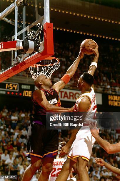 Charles Barkley of the Phoenix Suns blocks a shot by the Houston Rockets circa 1995 during the NBA game in Houston, Texas. NOTE TO USER: User...