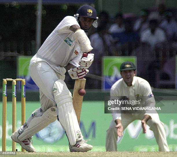 Sri Lankan batsman Hashan Tillakaratne bats as Australian captian Ricky Ponting looks on during the third day of the final test match between Sri...