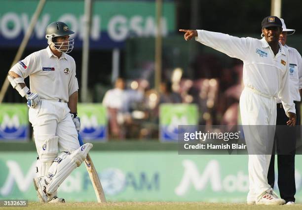 Hashan Tillakaratne of Sri Lanka and Justin Langer of Australia look on, Langer has been charged with bringing the game into disrepute after...