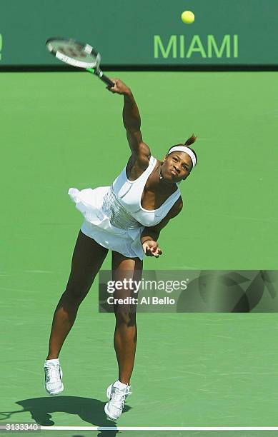 Serena Williams of the USA serves during the warm up against Marta Marrero of Spain during The Nasdaq 100 on March 26, 2004 in Miami, Florida.