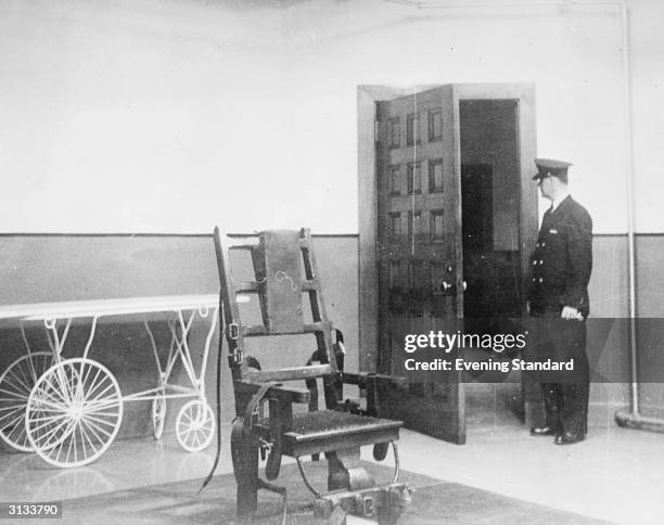 Prison guard stood in the Electric Chair room at Sing Sing Prison, New York.