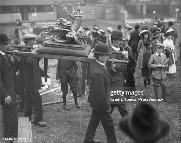 Group of men carrying the Horn of Plenty in a procession during the Eisteddfod at Birkenhead.