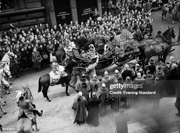 Crowds watching a parade to celebrate the proclamation of Queen Elizabeth II's accession to the English throne.