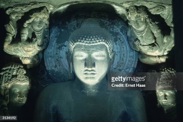 Relief carving of a Buddha in the Ajanta caves in Maharashtra State in central India dating from between 200 BC and 650 AD.