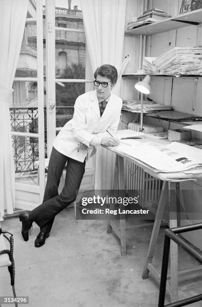 French fashion designer Yves Saint-Laurent working at his fashion house in Paris.