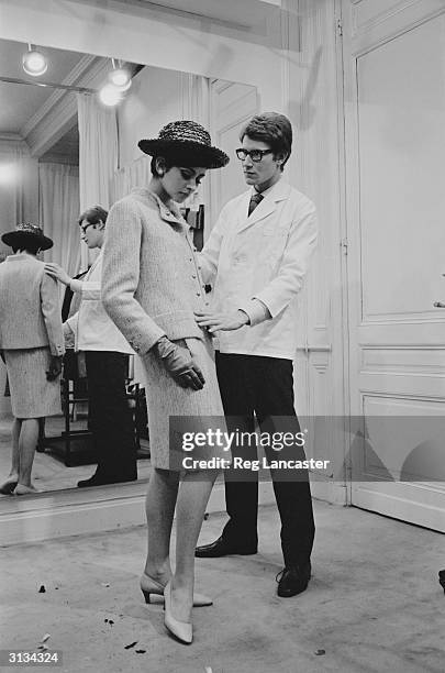 Yves Saint-Laurent, ex-wonder boy of Dior, working with a fashion model at his own fashion house in Paris.
