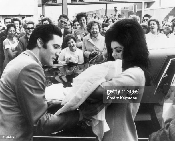 Elvis and Priscilla Presley with their daughter, Lisa Marie, born on 2nd February.