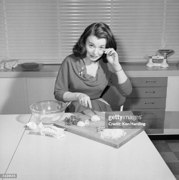 British film actress Anne Heywood chops the ingredients for a low calorie vegetarian hamburger which she has invented.