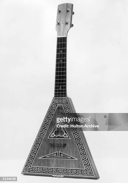 Russian balalaika with four strings, decorated with a key pattern.