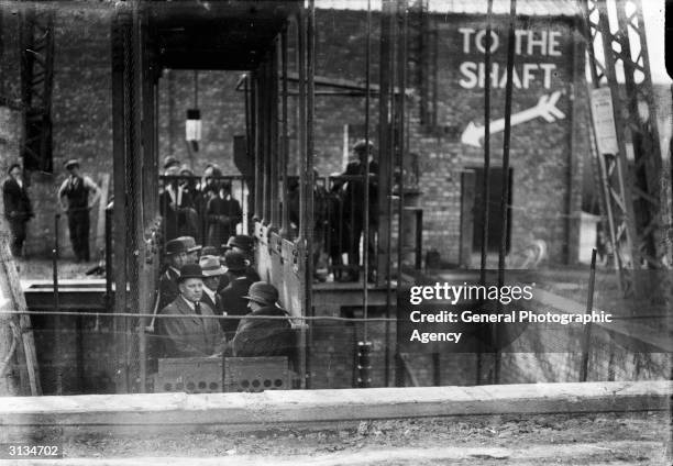 Lift lowers a group of men into a model mine shaft built at the British Empire Exhibition in Wembley, London.