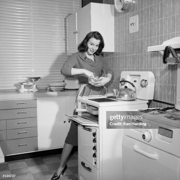 British film actress Anne Heywood mixing the ingredients for a low calorie vegetarian hamburger which she has invented.