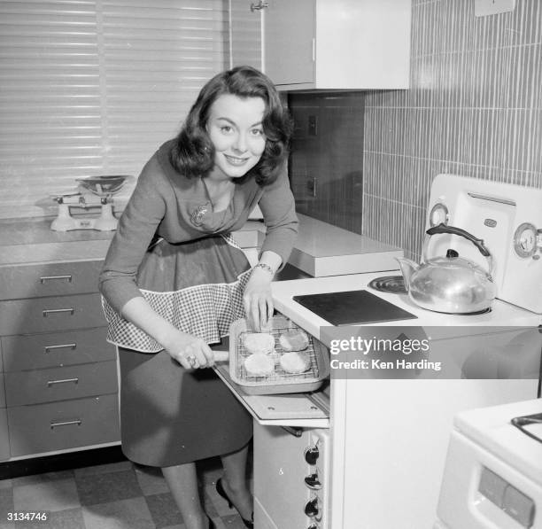 British film actress Anne Heywood grills a low calorie vegetarian hamburger which she has invented.