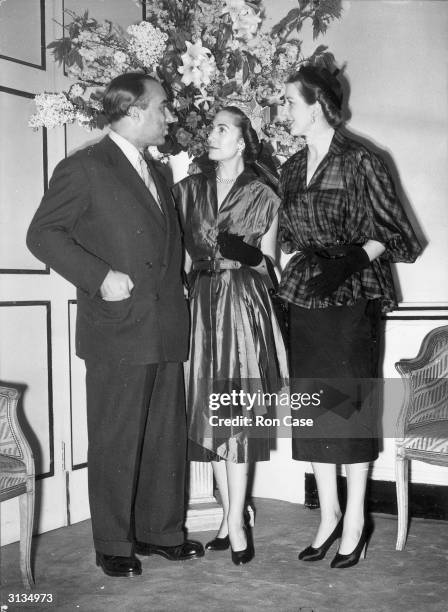 French fashion designer Marcel Rochas with his wife and one of his models, Susan Ward , at a press reception at the Savoy Hotel in London.