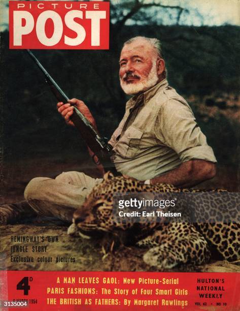 Author and big game hunter Ernest Hemingway with rifle and a dead leopard. Original Publication: Picture Post - Cover - pub.1954