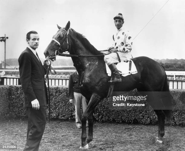 American high society millionaire and race horse owner, William Woodward Junior, with one of his racehorses 'Noshua'. Woodward was shot and killed by...