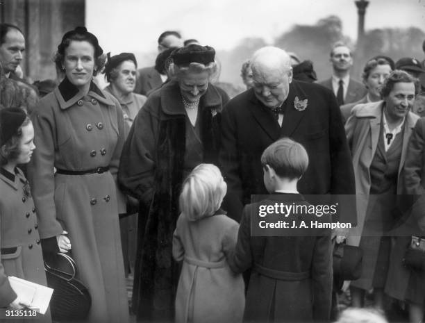 British Conservative politician Winston Churchill and his wife, Clementine, chatting to two of their grandchildren, Emma and Nicholas Soames, at the...