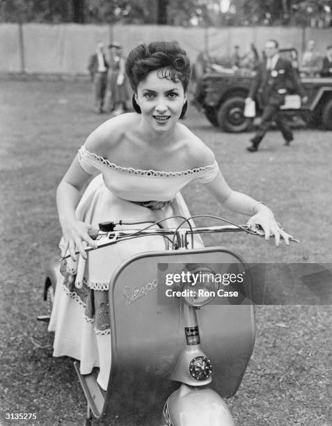 Italian actress Gina Lollobrigida attends the Great Film Garden Party at Morden Hall Park in Surrey, on a Vespa motor scooter. She is in Britain to...
