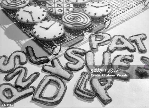 Small iced cakes and alphabet biscuits.