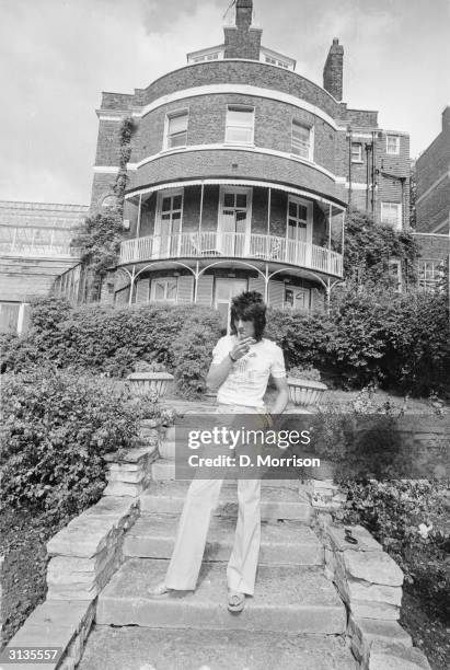 Ron Wood, a guitarist with the Rolling Stones amongst other groups, in the garden of his London studio and home, the Wick.