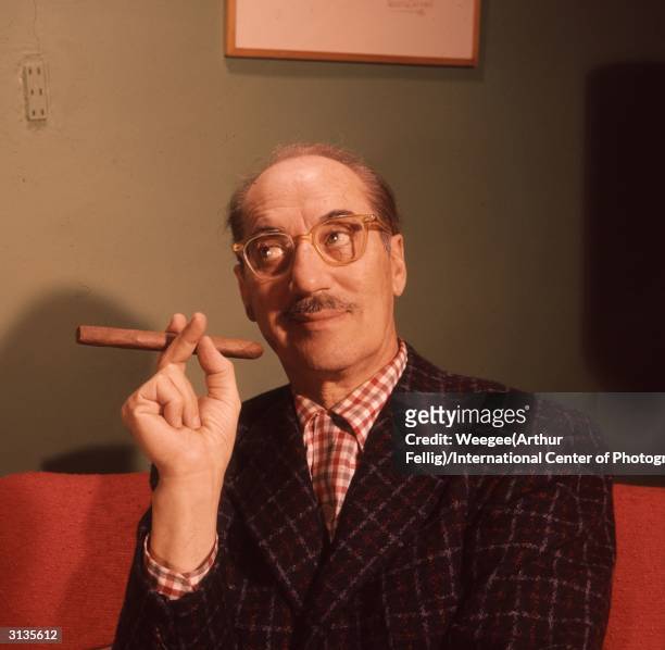 American comic Groucho Marx , born Julius Henry Marx, with his trademark cigar and spectacles.
