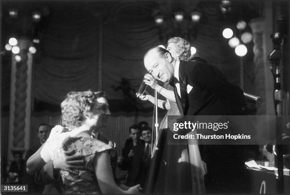 A young couple speak to dance band leader Oscar Rabin at the Lyceum ...