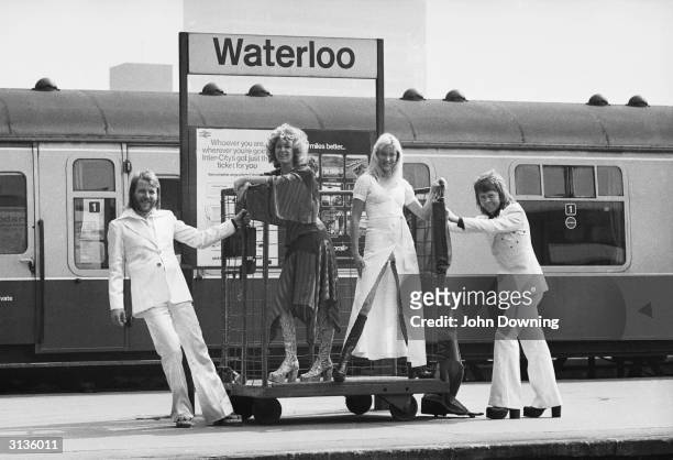 Swedish pop stars , Benny Andersson, Anni-Frid Lyngstad, Agnetha Faltskog and Bjorn Ulvaeus of the Swedish pop group ABBA posing at Waterloo railway...