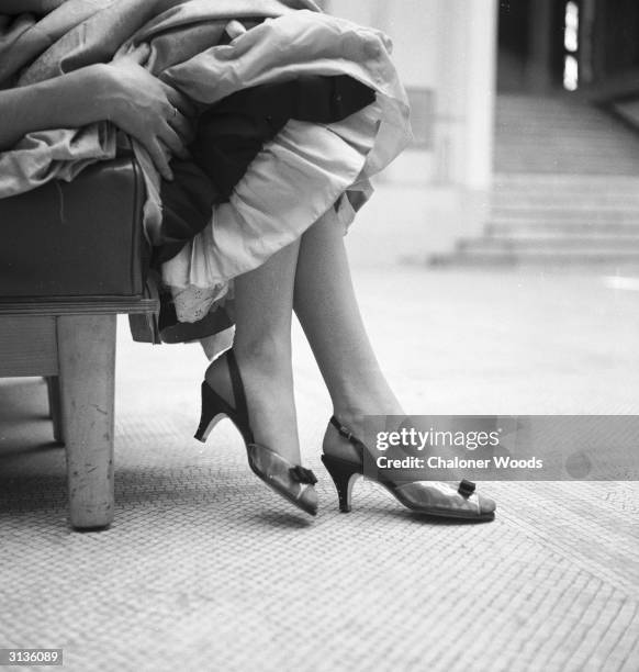 Sling back, peep-toed evening shoes with slim high heels.