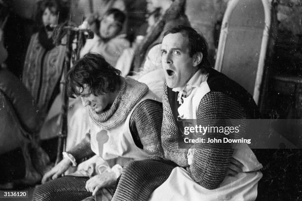 Python members Michael Palin and John Cleese, dressed and ready for action on the set of 'Monty Python and the Holy Grail'.