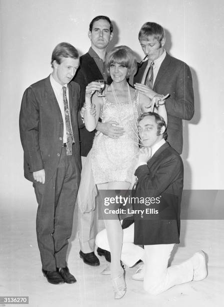 English comedians Tim Brooke-Taylor, John Cleese, Graham Chapman and Marty Feldman with Aimi McDonald, a dancer and the co-host of the 'At Last the...