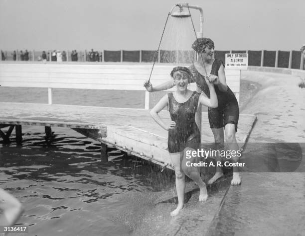 Women bathers at the lido, Southport, Lancashire take a shower.