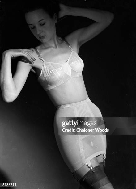 Woman modelling a bra and suspender-belt corset.