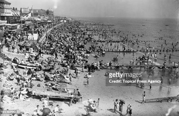 View from the pier at Bognor Regis during a heatwave showing the crowded beach .