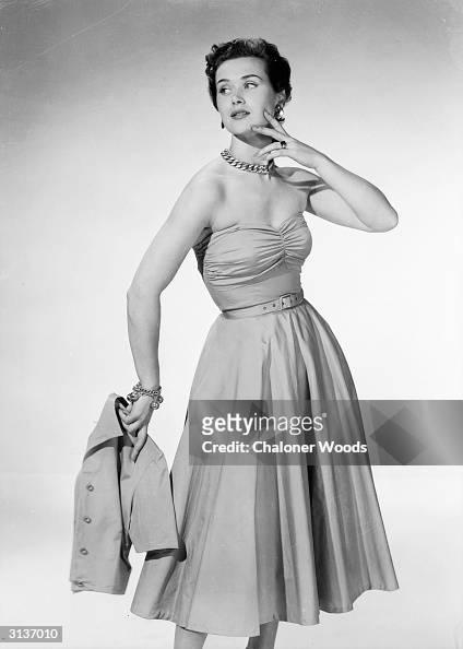 A woman modelling a strapless party dress with a matching... News Photo ...