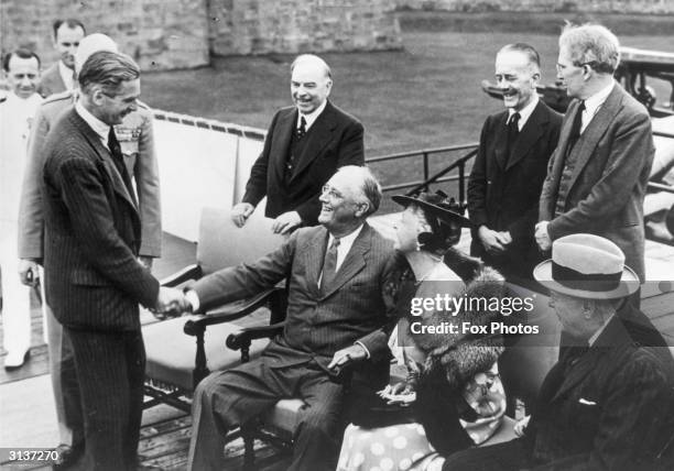 Future British Prime Minsiter Anthony Eden shakes hands with American president Franklin Delano Roosevelt after planning the Normandy invasion at the...