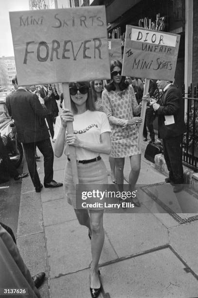 Girls from the British Society for the Protection of Mini Skirts stage a protest outside the House of Dior, for its 'unfair' treatment of mini skirts.