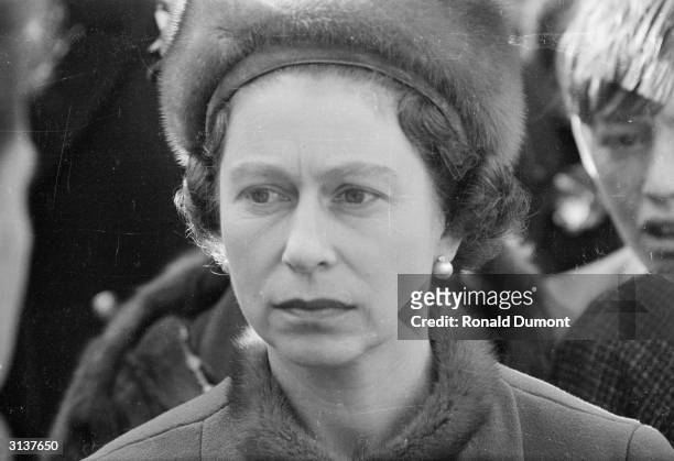 Queen Elizabeth II visits Aberfan in Wales, a few days after a coal tip collapsed on the local school, killing 141 children and four adults.