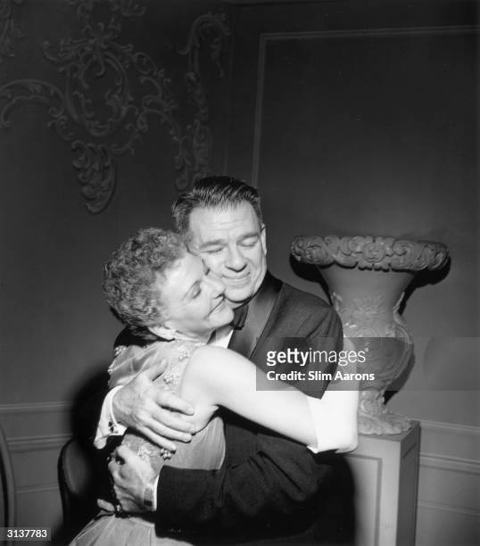 Actress Mary Martin getting a hug from lyricist Oscar Hammerstein II at a party given in her honour on the occasion of the 5th anniversary of South...
