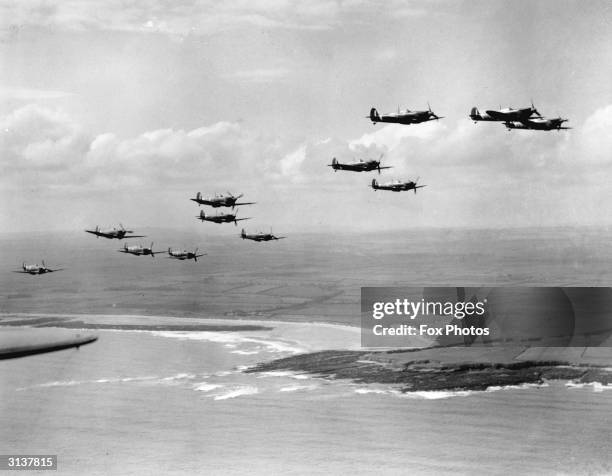 Spitfires on patrol over a coastline during the Battle of Britain.