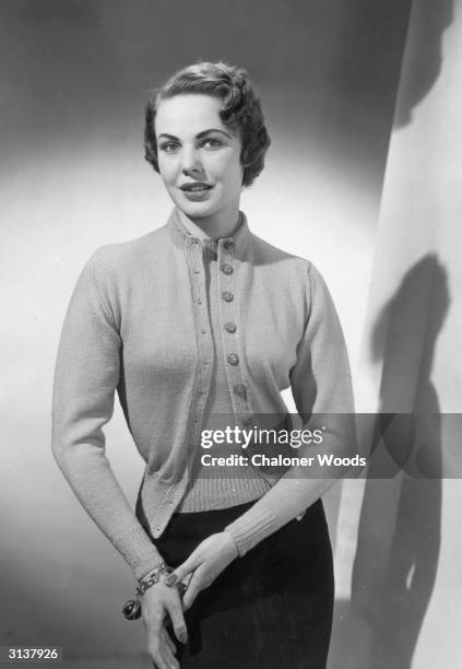 Model wearing a knitted cardigan and blouse.