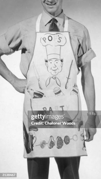 Man modelling a cheerfully patterned apron from the Harrods Christmas catalogue.