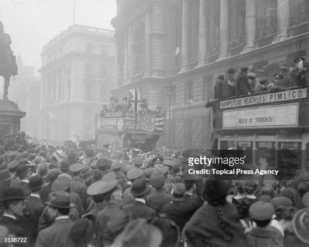 Crowds and buses in London when the armistice was signed, bringing WW I to an end.