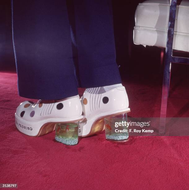 Patent leather polka dot platform shoes by Smerling Imports with miniature goldfish bowls inside the heels.