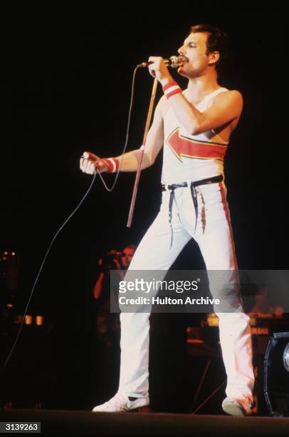 Freddie Mercury , lead singer of 70s hard rock quartet Queen, in concert at Leeds Football Club.