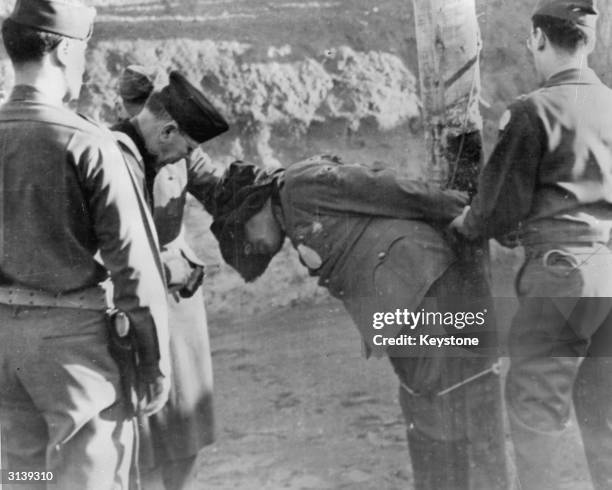 The first Nazi General to be executed, Anton Dostler, after being shot by an US Army firing squad. He was tried by an American military tribunal for...